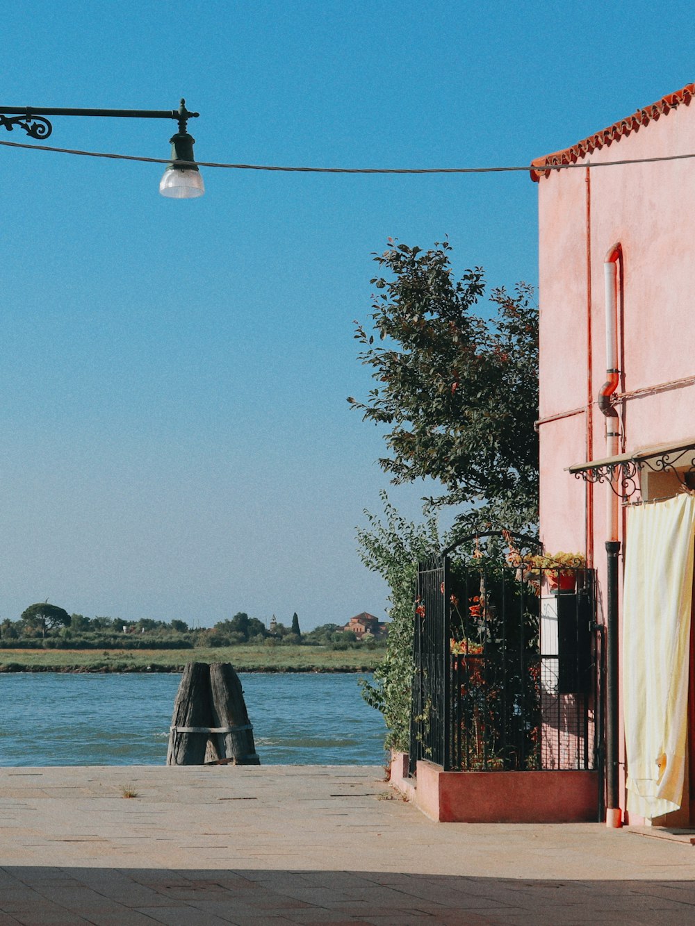 a street light hanging over a body of water