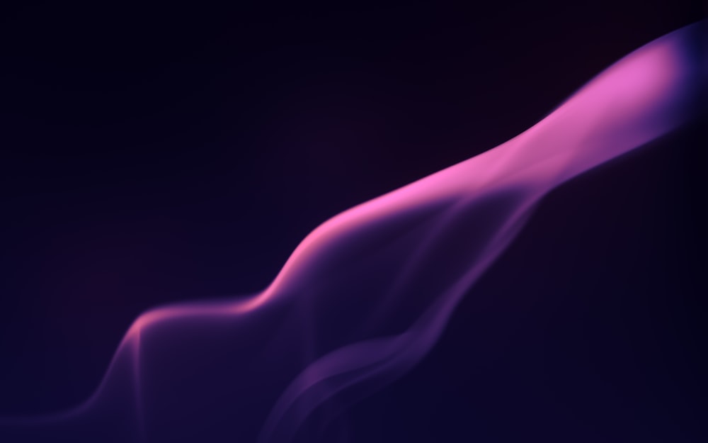 a blurry image of a purple smoke on a black background