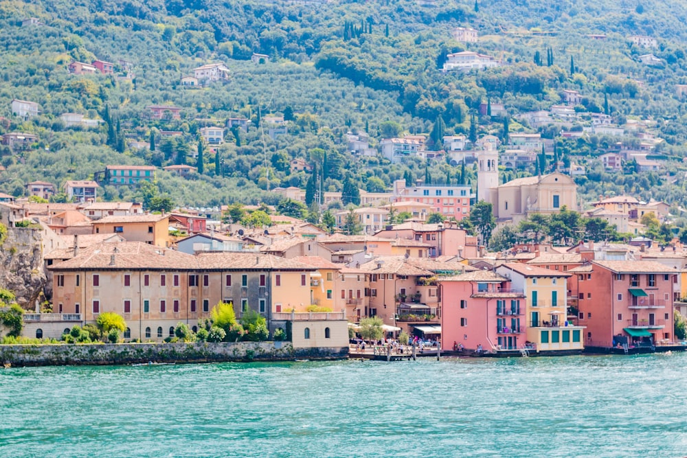 a group of buildings sitting on top of a lush green hillside