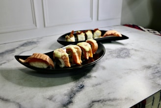 Plates of sushi served on a wooden table during a private event.