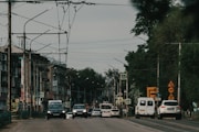 a street filled with lots of traffic next to tall buildings