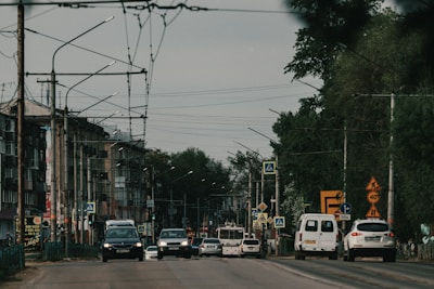 A busy city street with various vehicles, illustrating the dynamic environment where drivers operate.