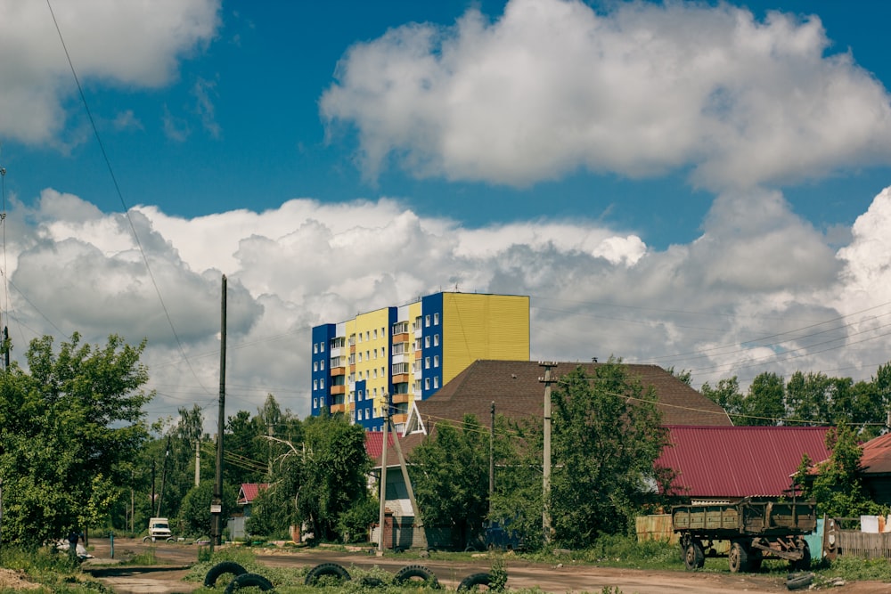 a yellow and blue building sitting on the side of a road