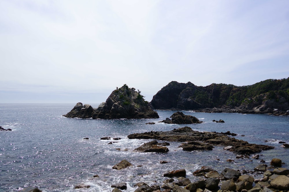 a body of water surrounded by rocks and trees