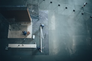 Side angle of a worker inspecting a waterproofed exposed surface with certified materials visible