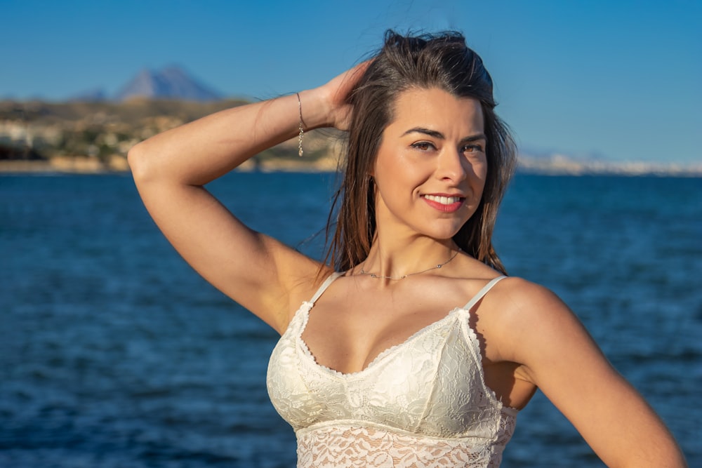 a beautiful woman in a white bikini posing for a picture