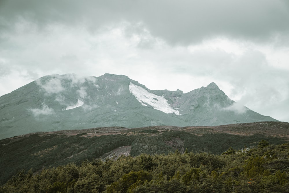 a view of a mountain with clouds in the sky