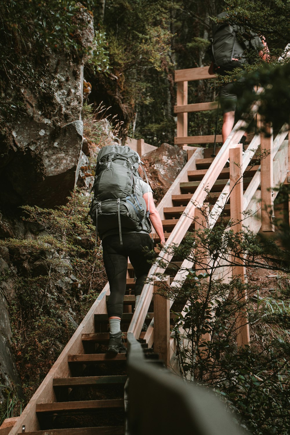 a person with a backpack walking up a set of stairs