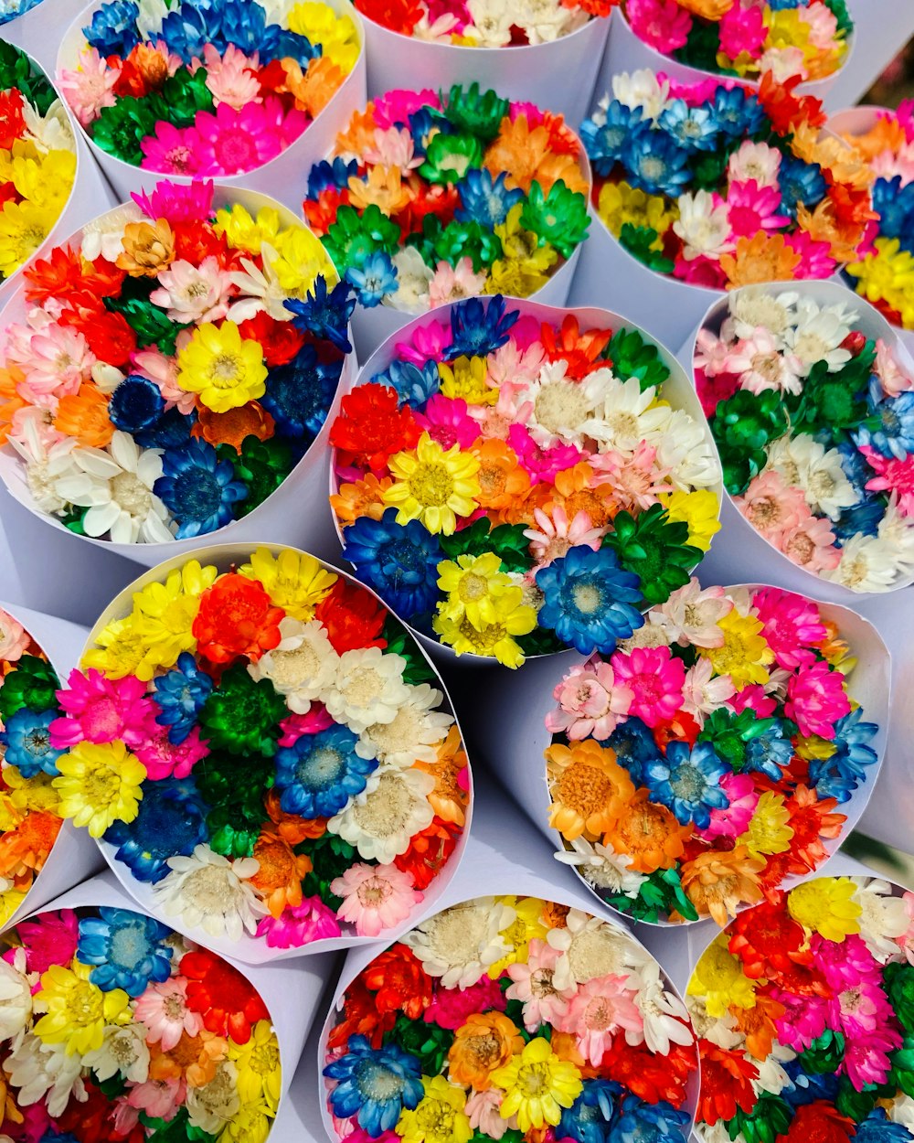 a table topped with lots of different colored flowers