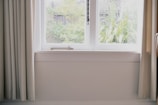 A bright living room with ceramic-tinted windows filtering sunlight.