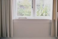 A bright room showcasing natural light through screens.
