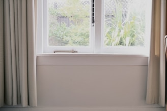 A bright room showcasing natural light through screens.