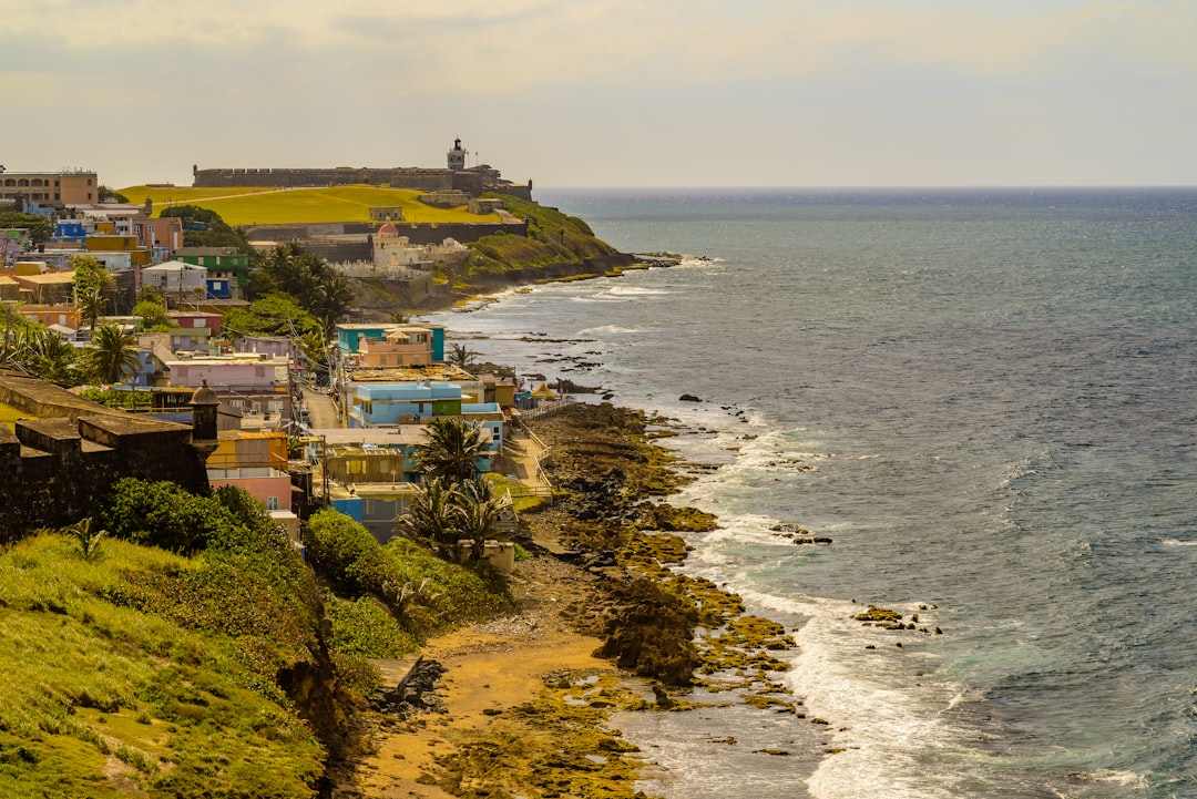 a view of the ocean and a city from a hill, Castillo San Cristóbal View