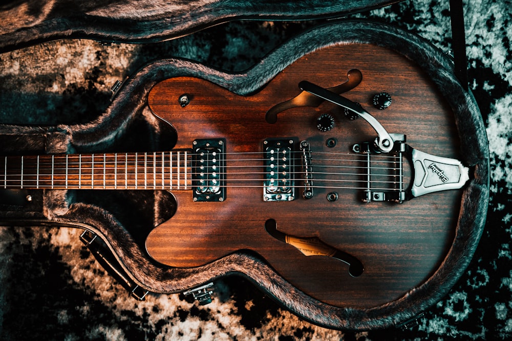 a close up of a guitar with a case