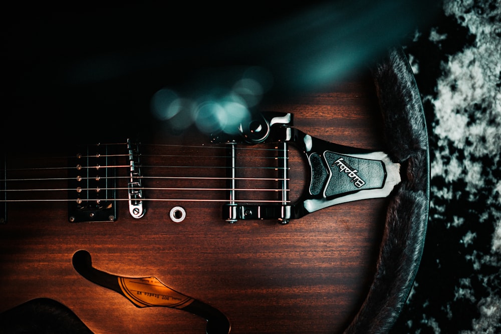 a close up of an electric guitar with a black background