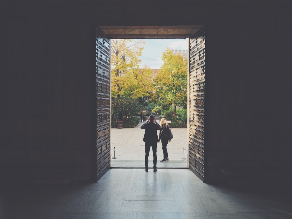 a couple of men standing in a doorway