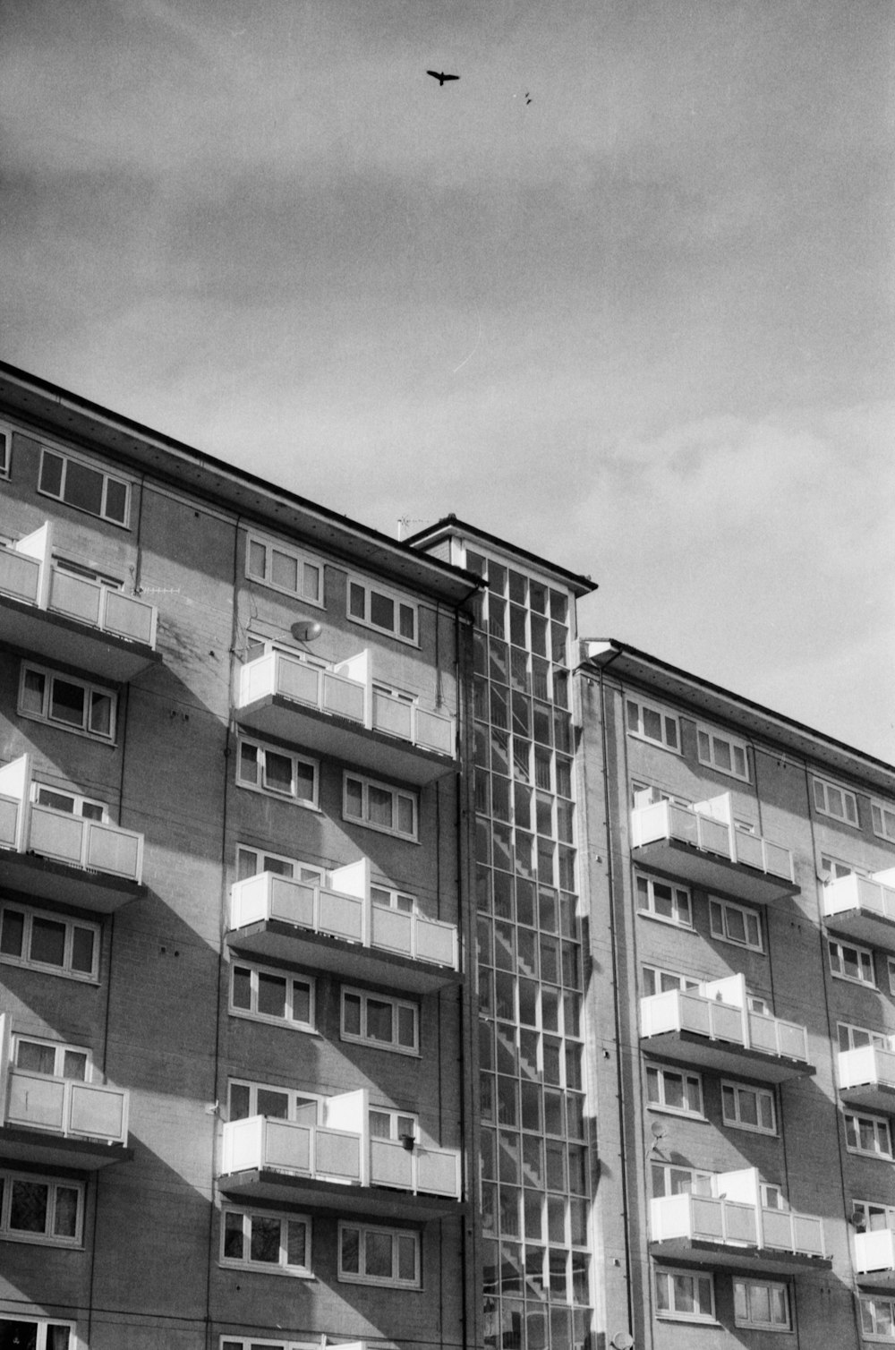 a black and white photo of a building with balconies