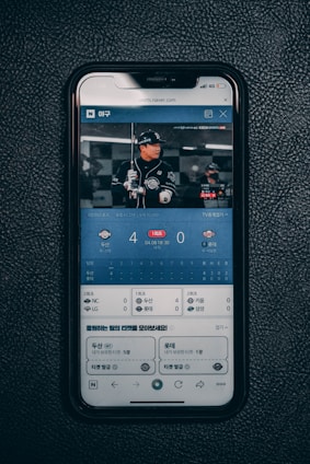a cell phone sitting on top of a black surface