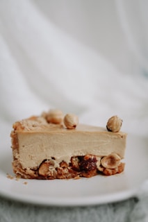 A slice of hedgehog cake with chocolate and nuts on a vintage plate.