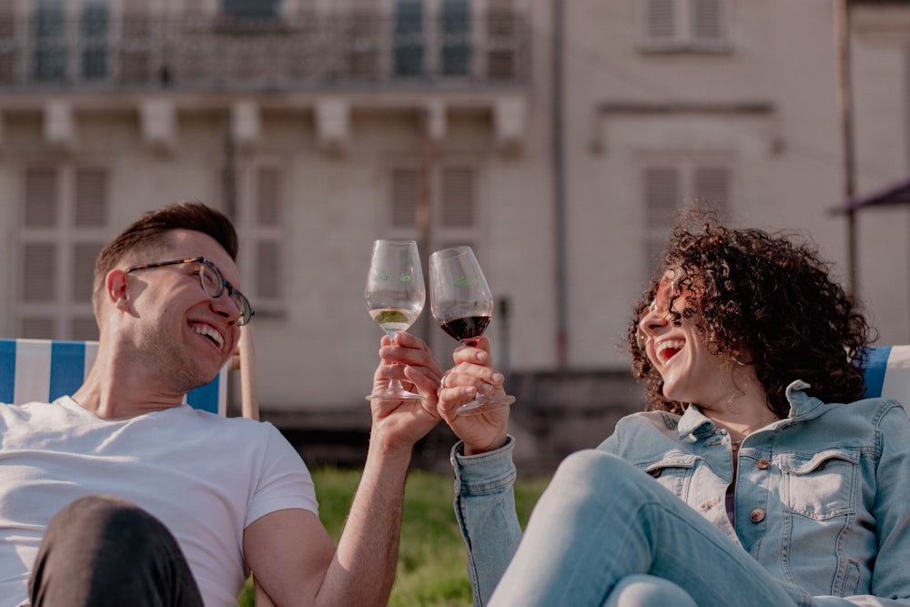 a man and a woman toasting with wine glasses