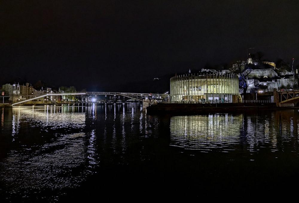 a night view of a building and a bridge