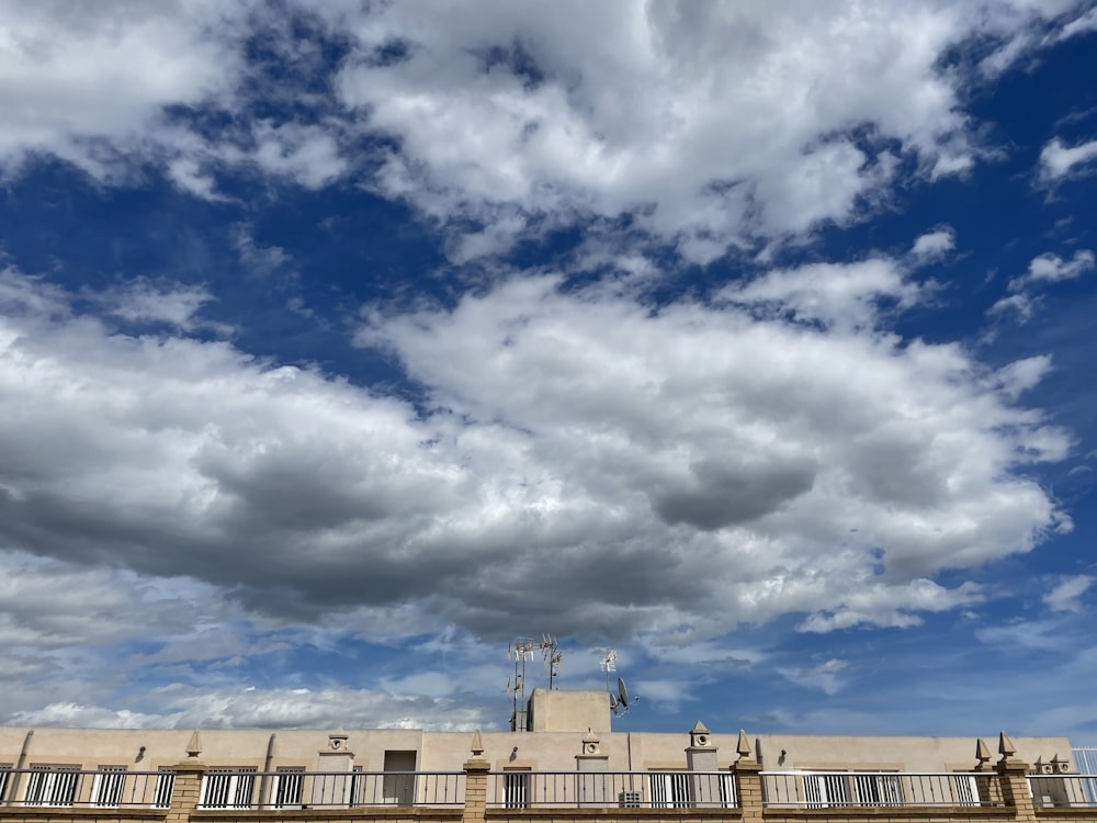 a very tall building with a lot of clouds in the sky