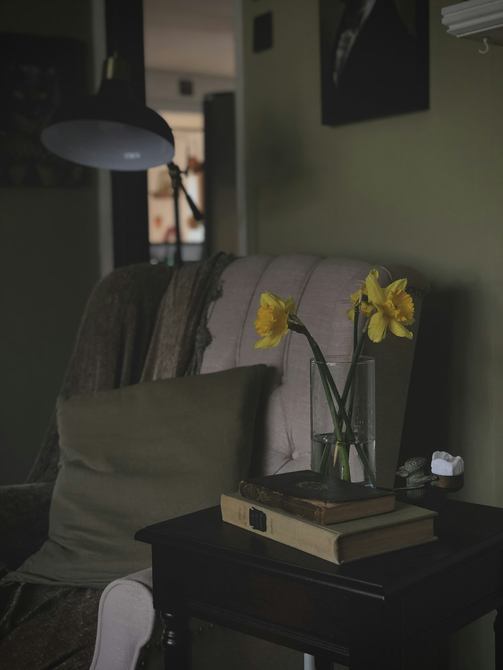 a table with a book and a vase of flowers on it