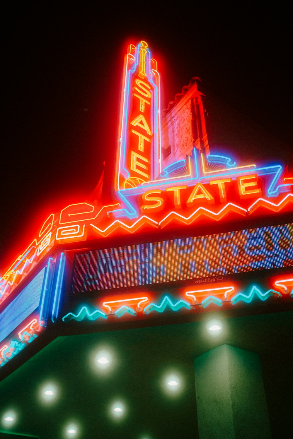 a theater sign lit up at night time
