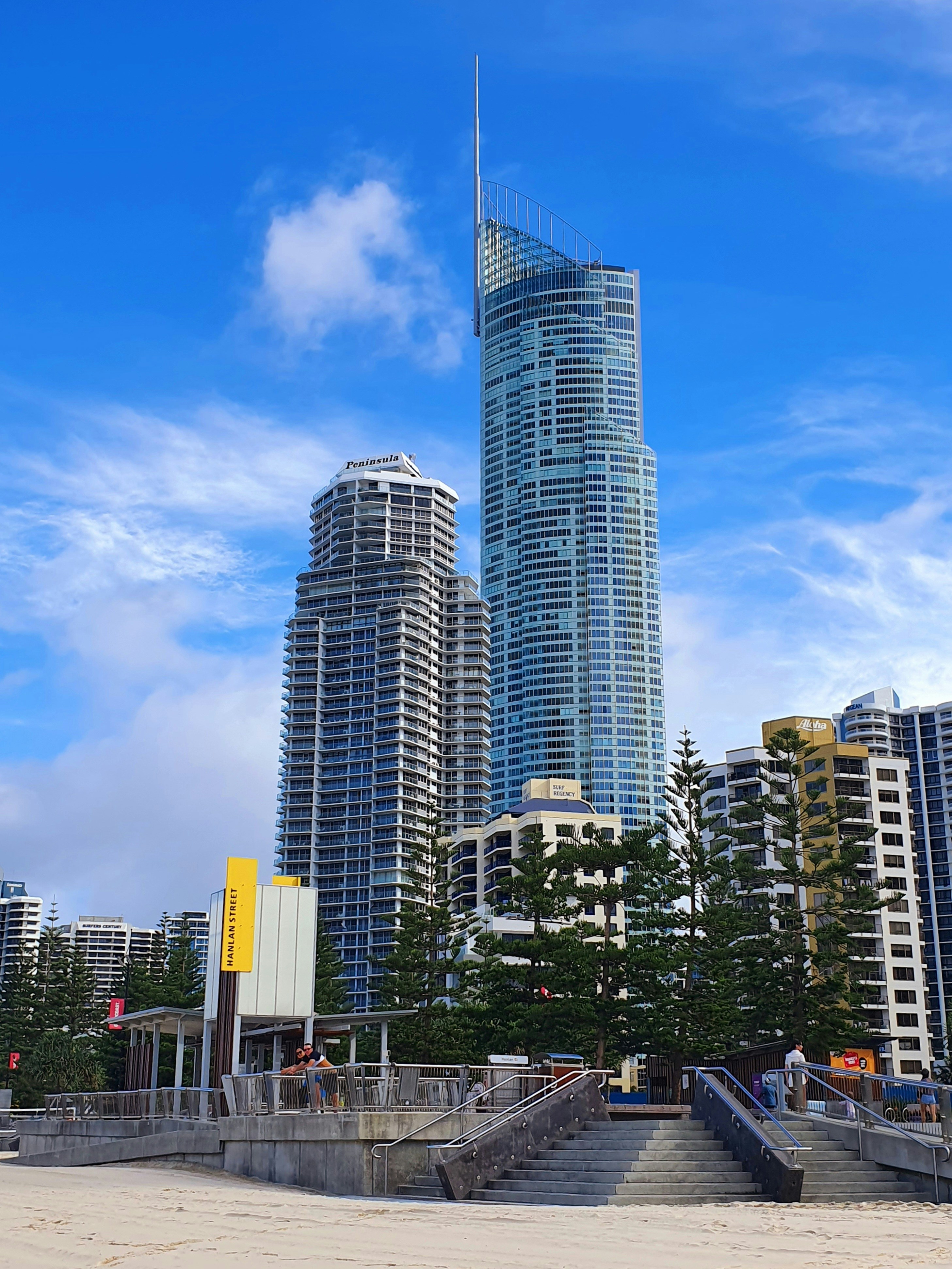 a very tall building sitting next to a bunch of tall buildings