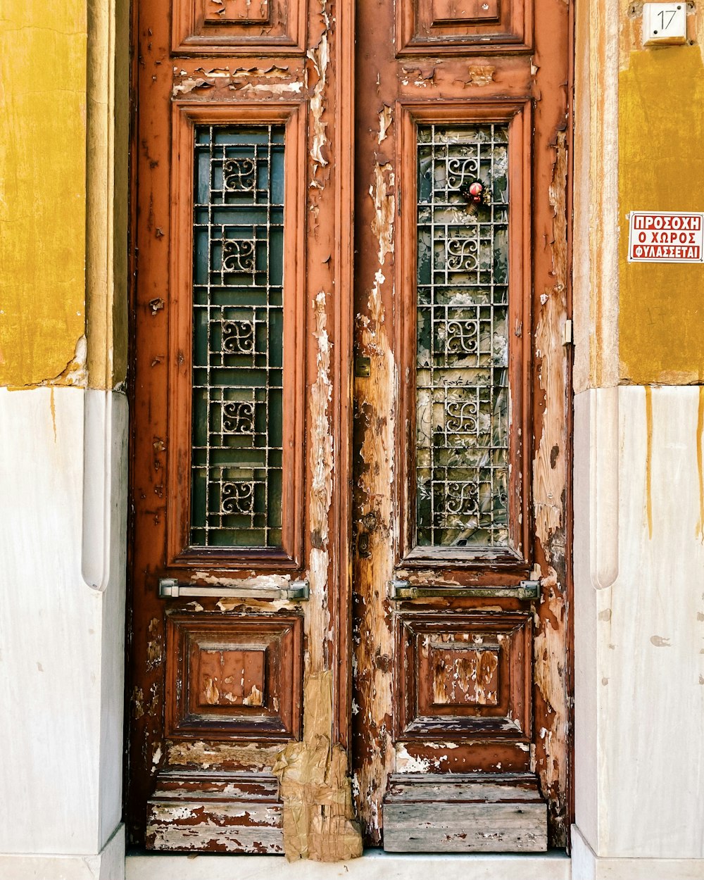 a pair of wooden doors with stained glass