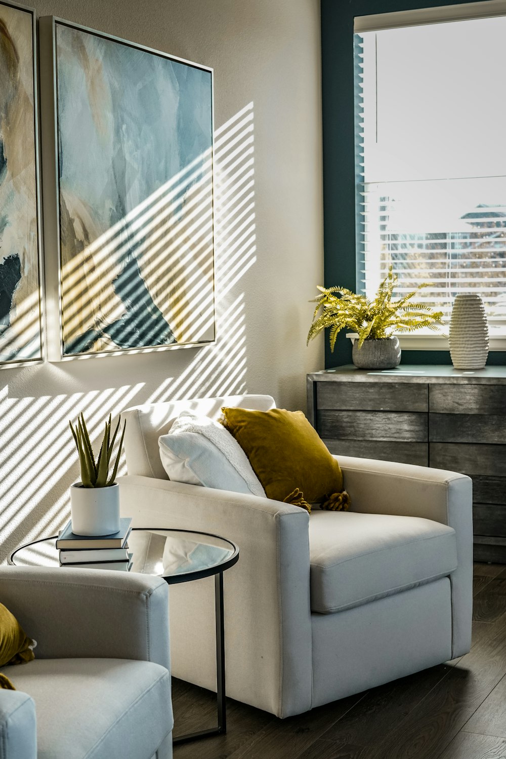 a living room filled with furniture and a painting on the wall