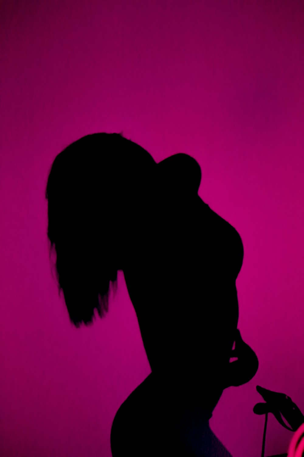 a silhouette of a woman in a dark room