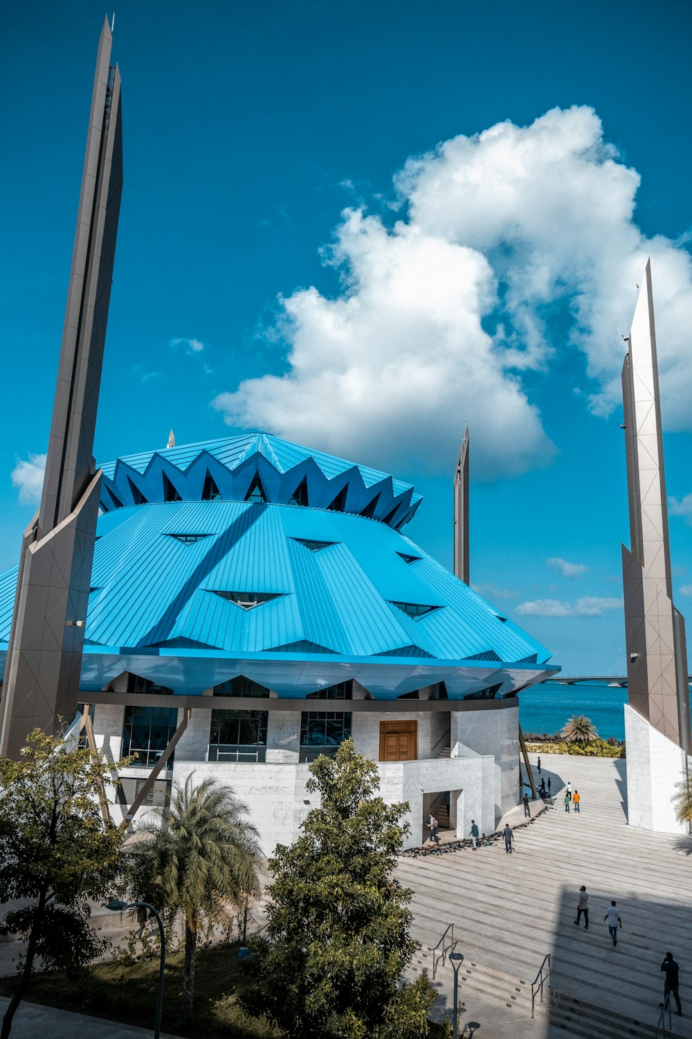 a building with a blue roof and two tall towers