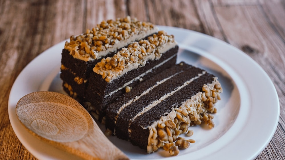 a piece of cake on a plate with a wooden spoon