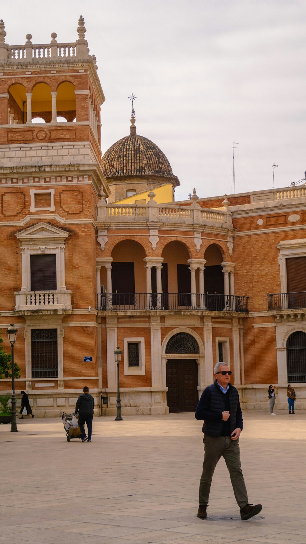 a man walking in front of a large building