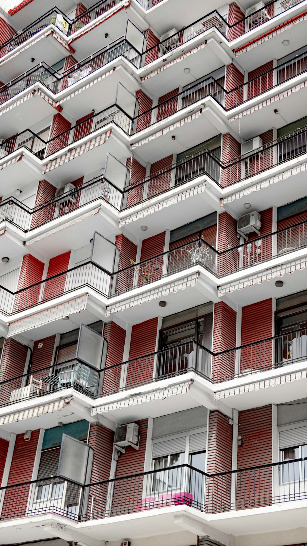 a red and white building with balconies and balconies