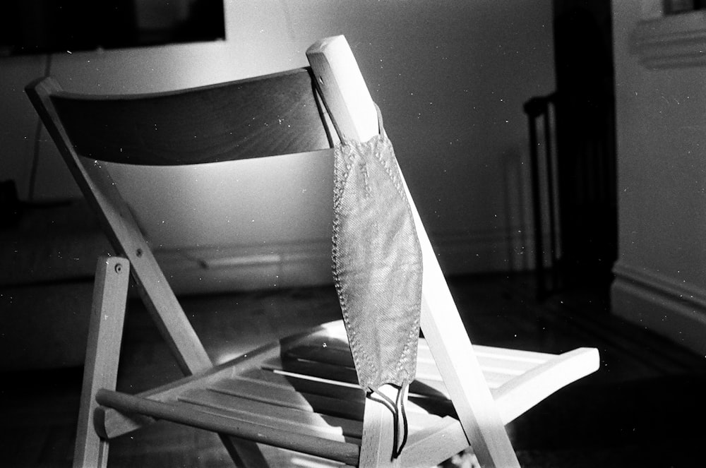 a black and white photo of a folding chair