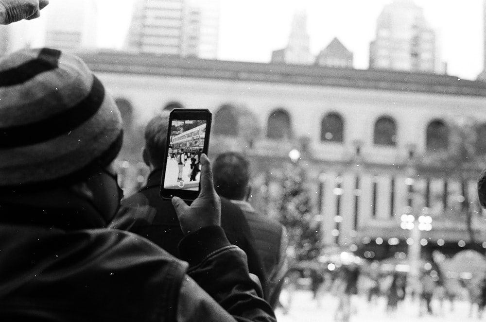 a person taking a picture with a cell phone