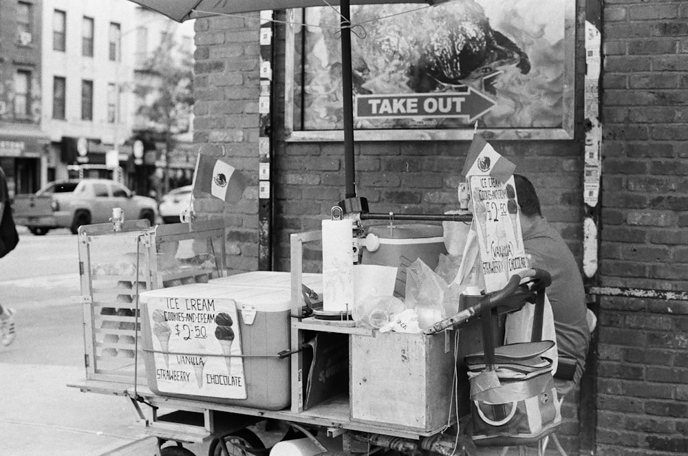 a black and white photo of a street vendor