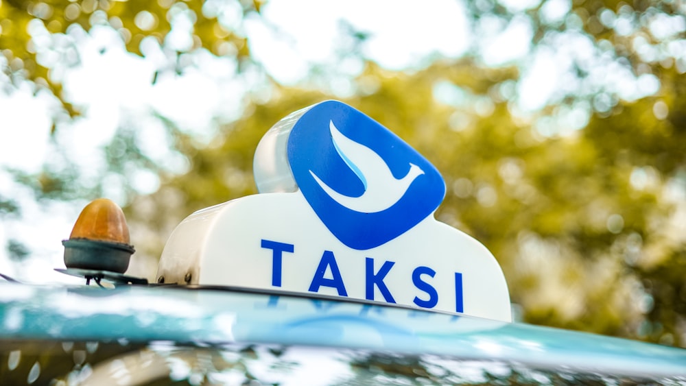 a close up of a sign on the roof of a car