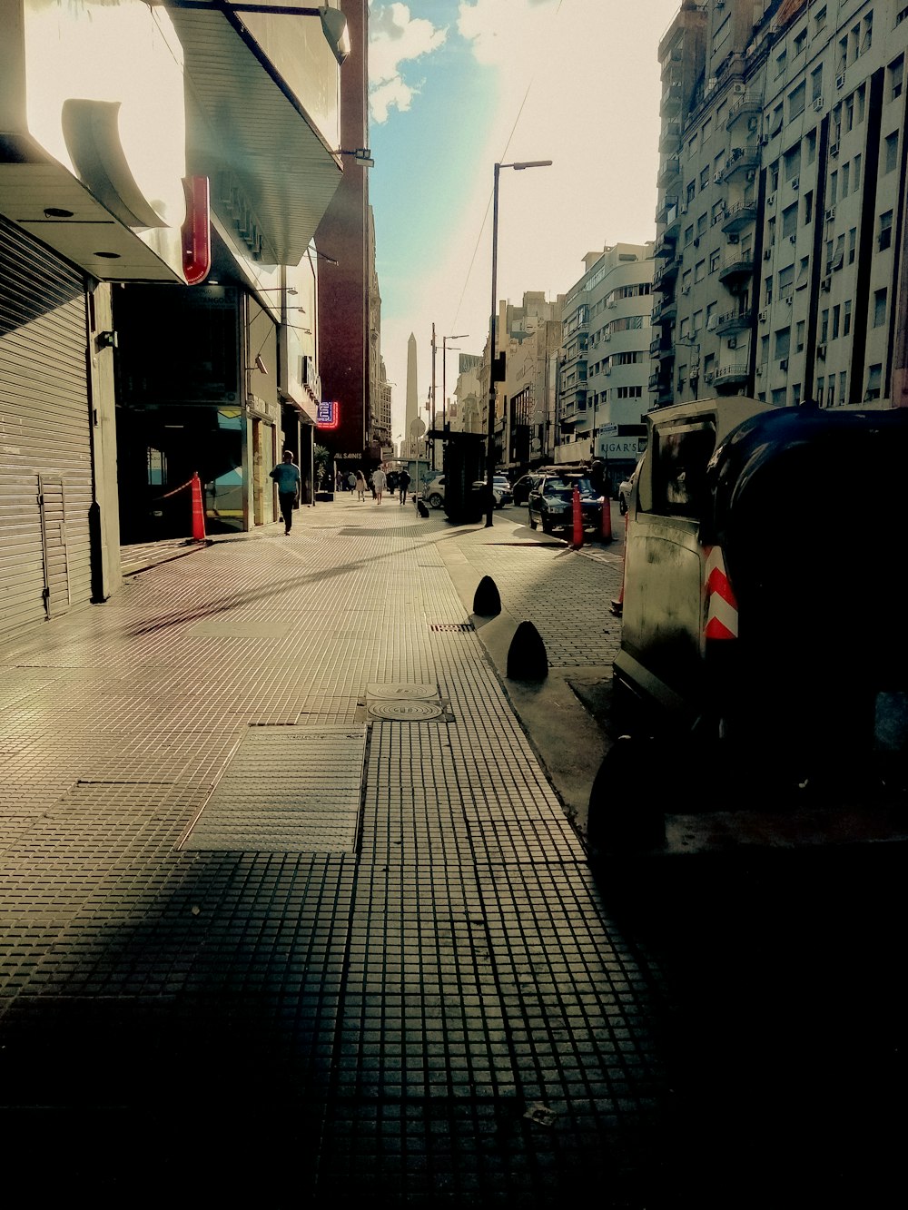 a city street with cars parked on the side of it