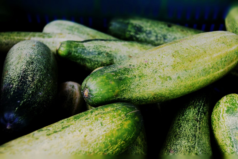 a pile of green cucumbers sitting next to each other