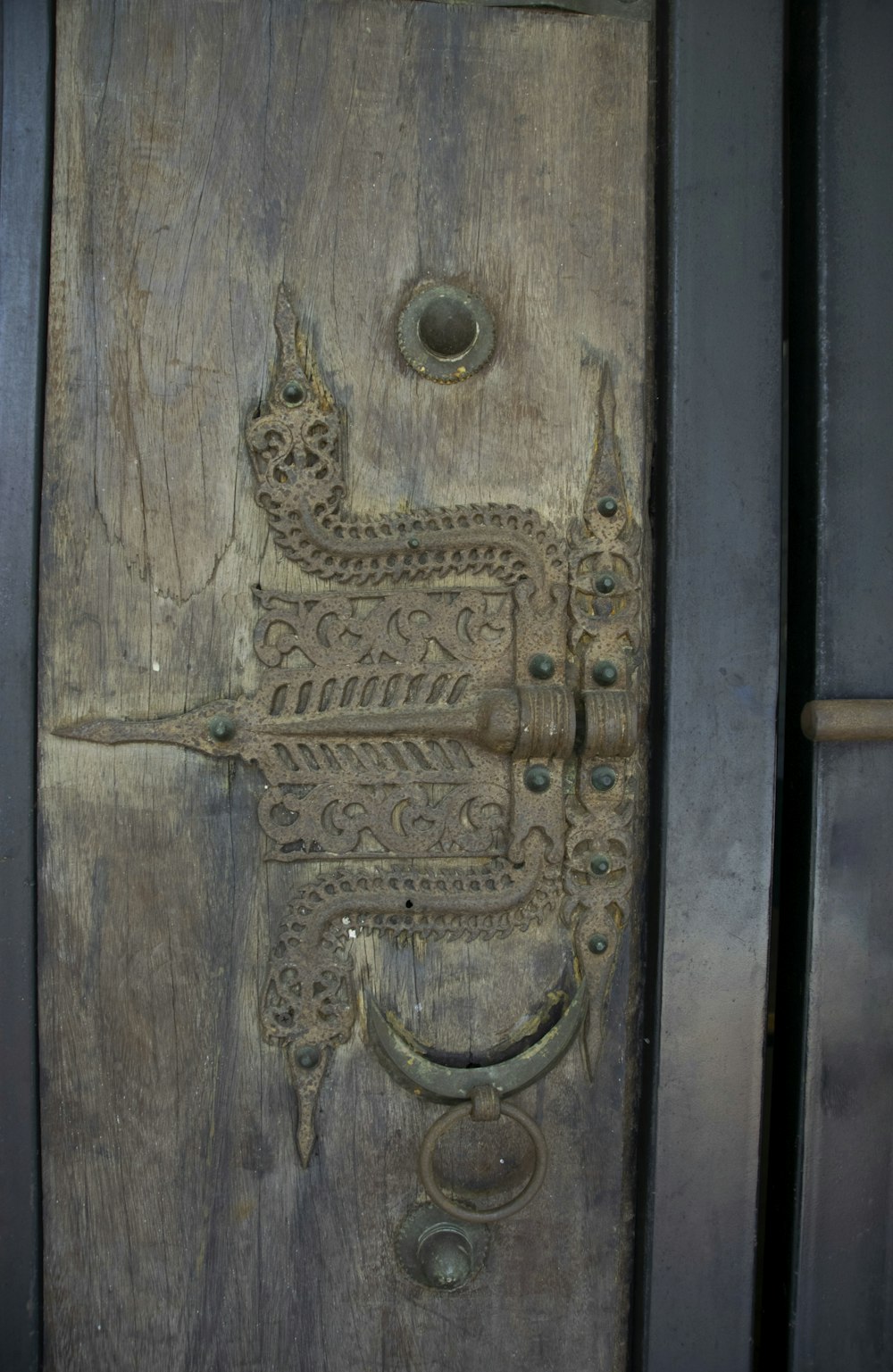 a close up of a wooden door with a metal handle