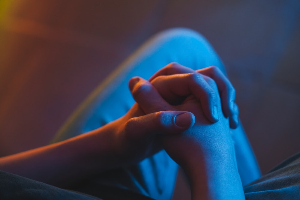 a woman's hands resting on a couch