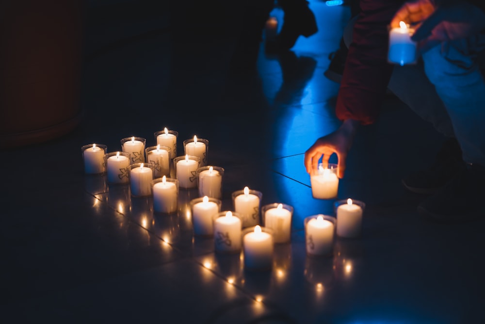 a group of lit candles sitting on top of a floor