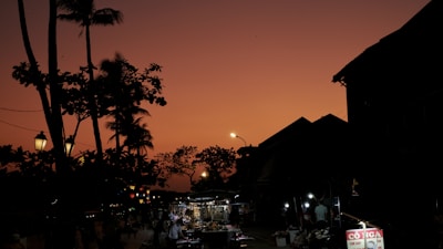 A sunset view of a bustling street market filled with vendors.