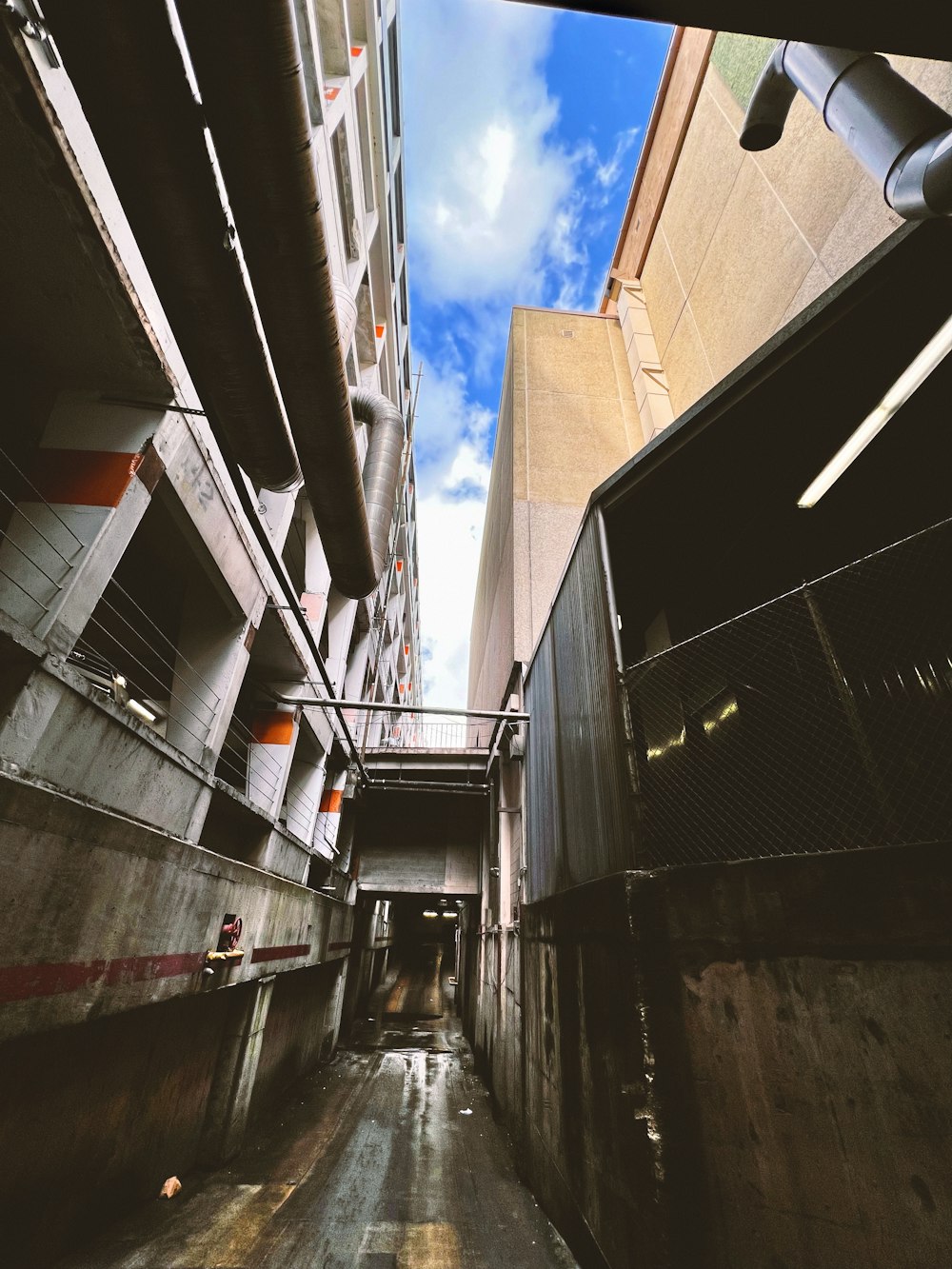 a narrow alley way with a blue sky in the background