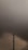 A tall telecommunications tower stands prominently against a backdrop of heavy, dark clouds. The sky has a tumultuous look, suggesting an impending storm or bad weather.