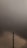 A tall telecommunications tower stands prominently against a backdrop of heavy, dark clouds. The sky has a tumultuous look, suggesting an impending storm or bad weather.