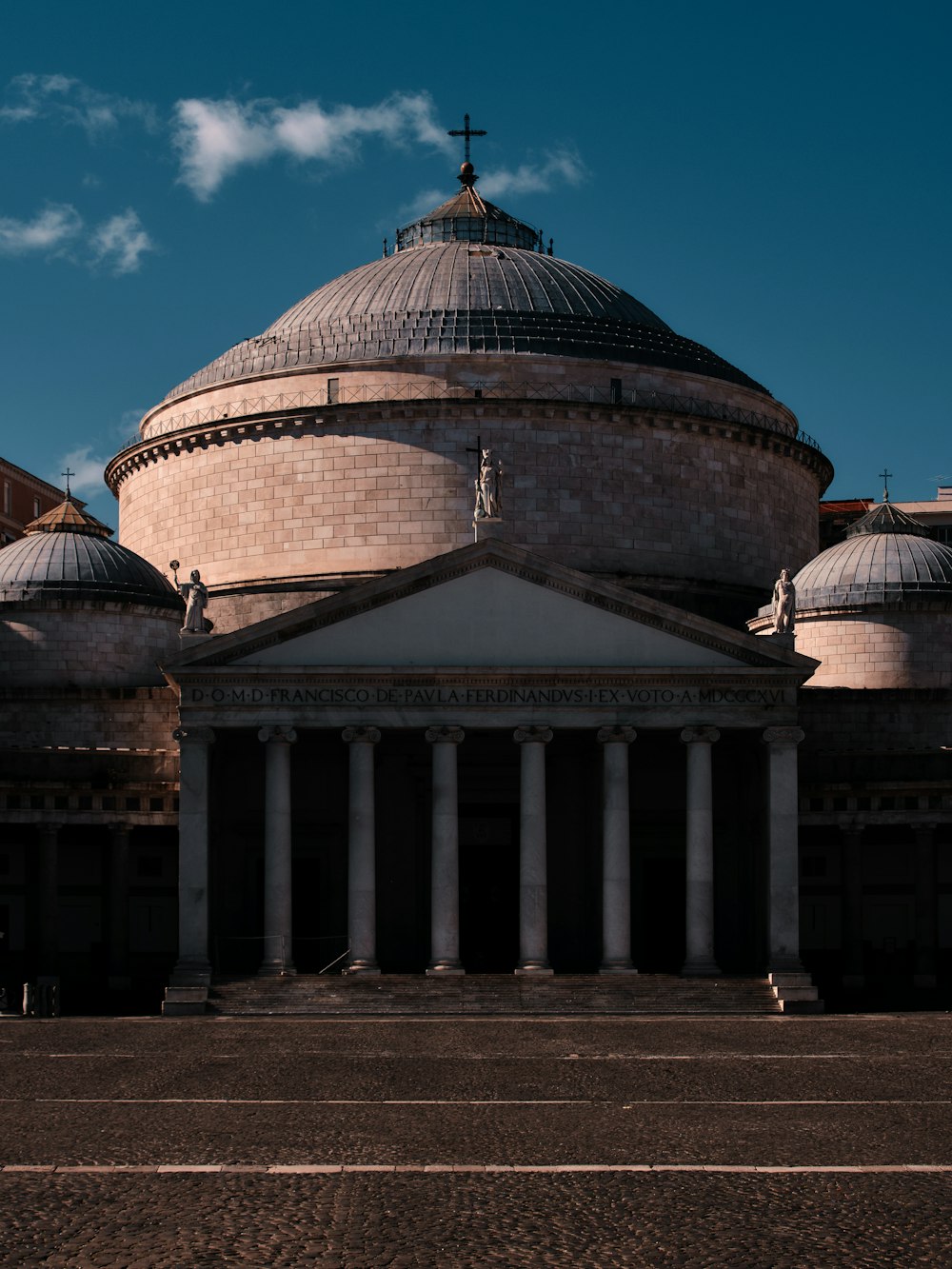 a large building with a cross on top of it